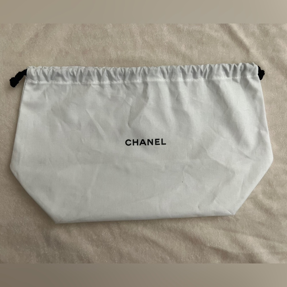 Chanel cosmetic bag, white with black print and pull closure